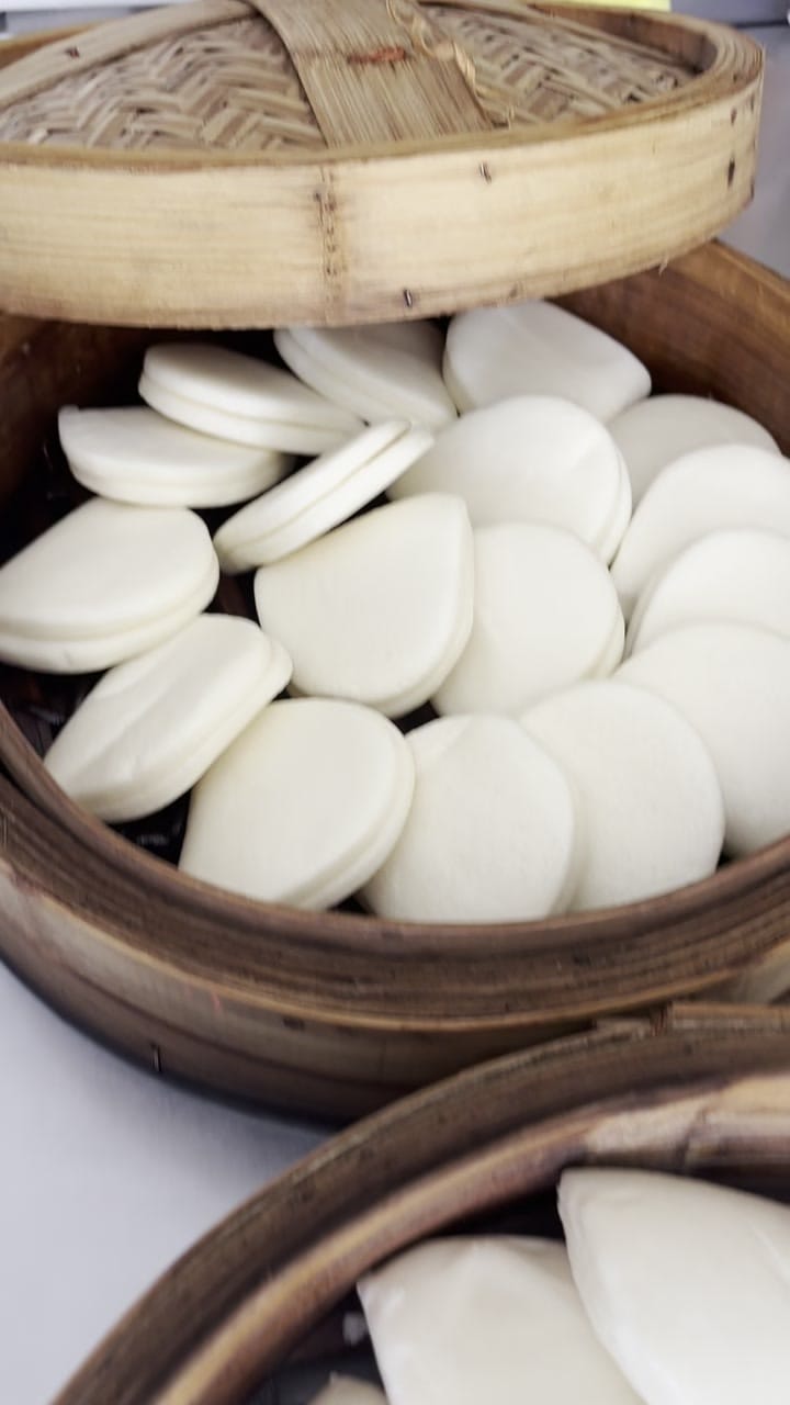 Bao buns lifted fresh from the steamer