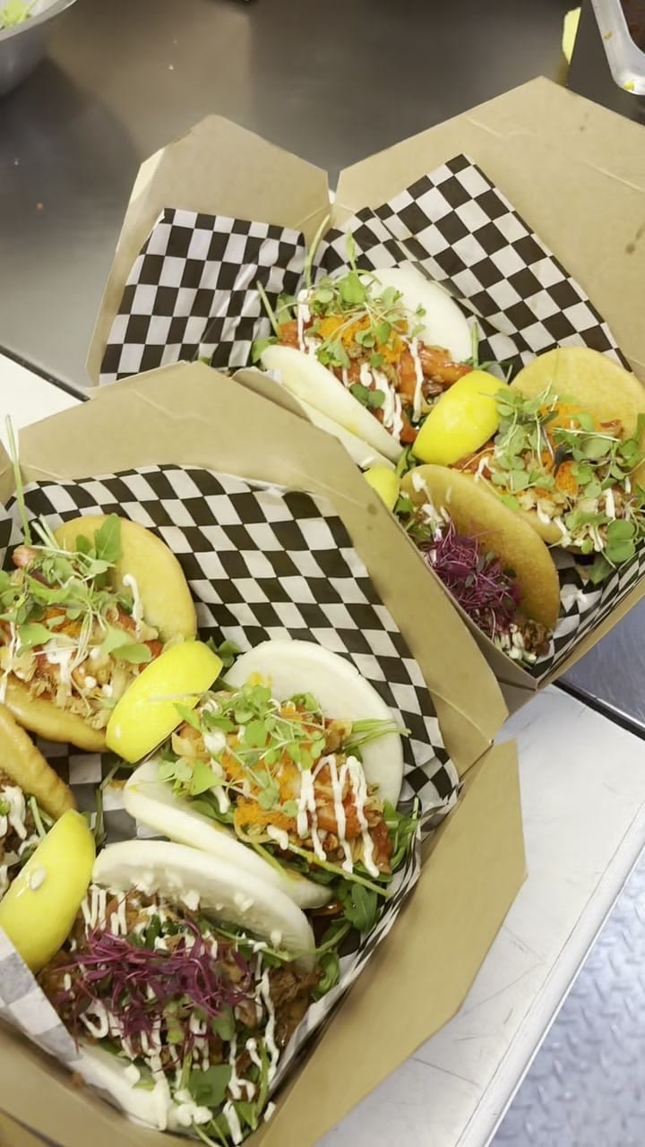 Finished bao buns packed in a kraft takeaway box